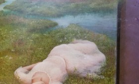 <b>Young woman lying in front of the river</b>
